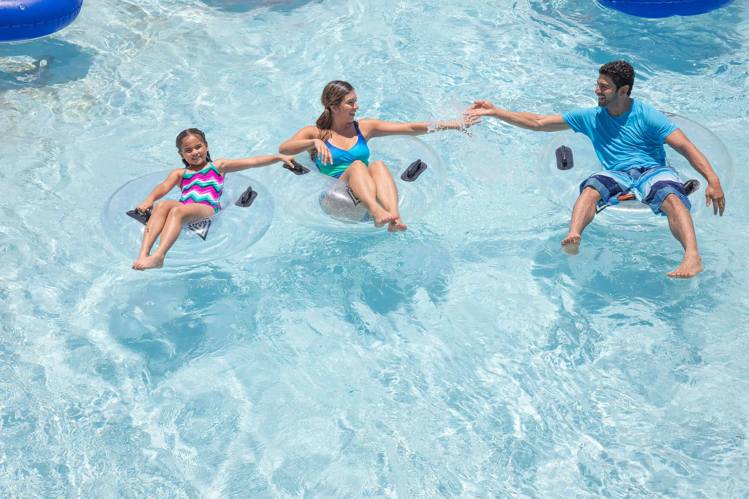 A group of people swimming in a pool of water