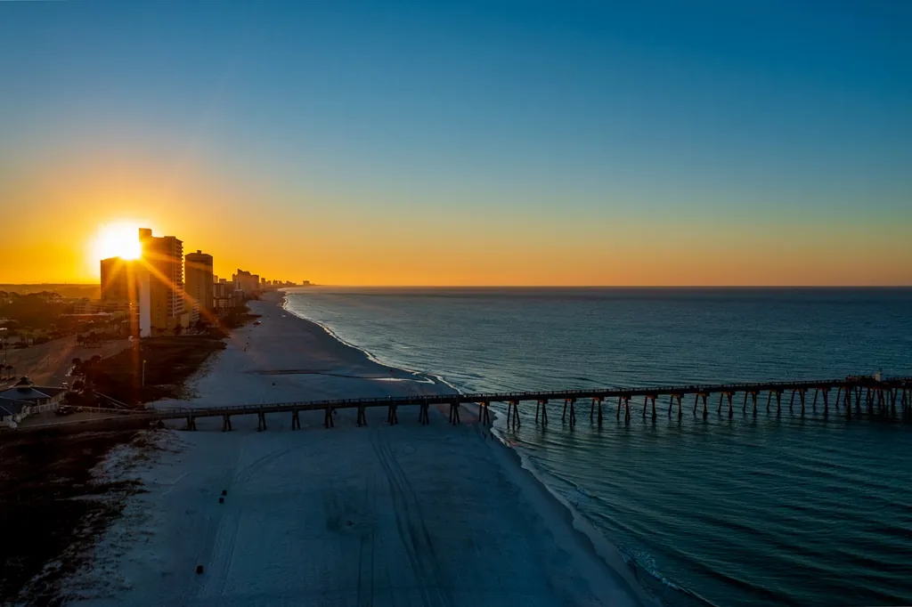 Drone photo of sunset over the Gulf of America on Panama City Beach, Florida.