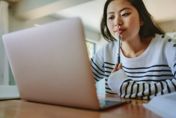 Young woman researches career opportunities post-graduation.
