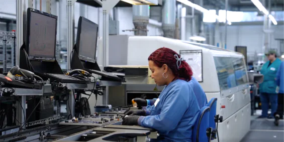 A woman working in an automated manufacturing facility