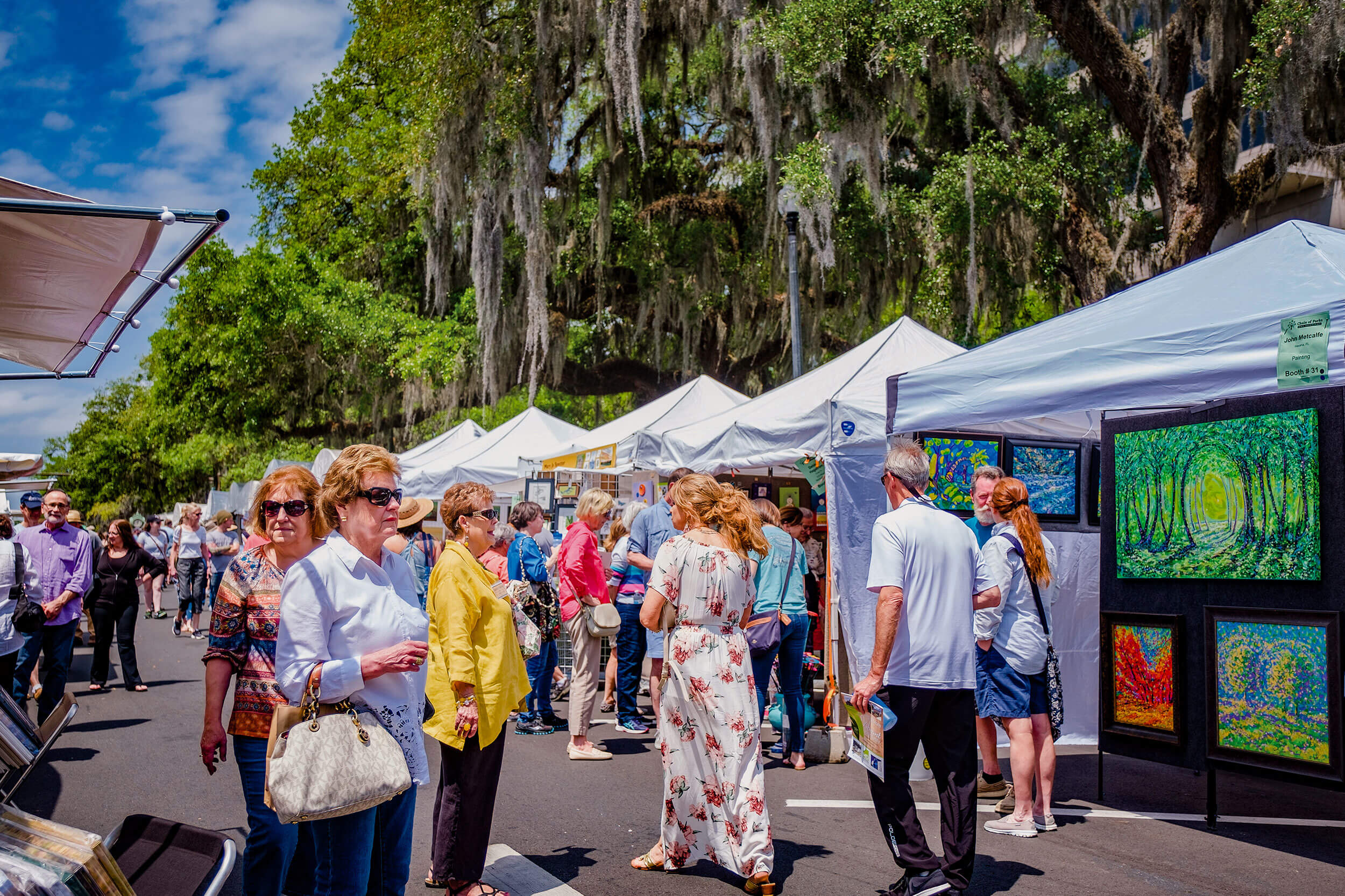 Crowds gather at outdoor art fair.