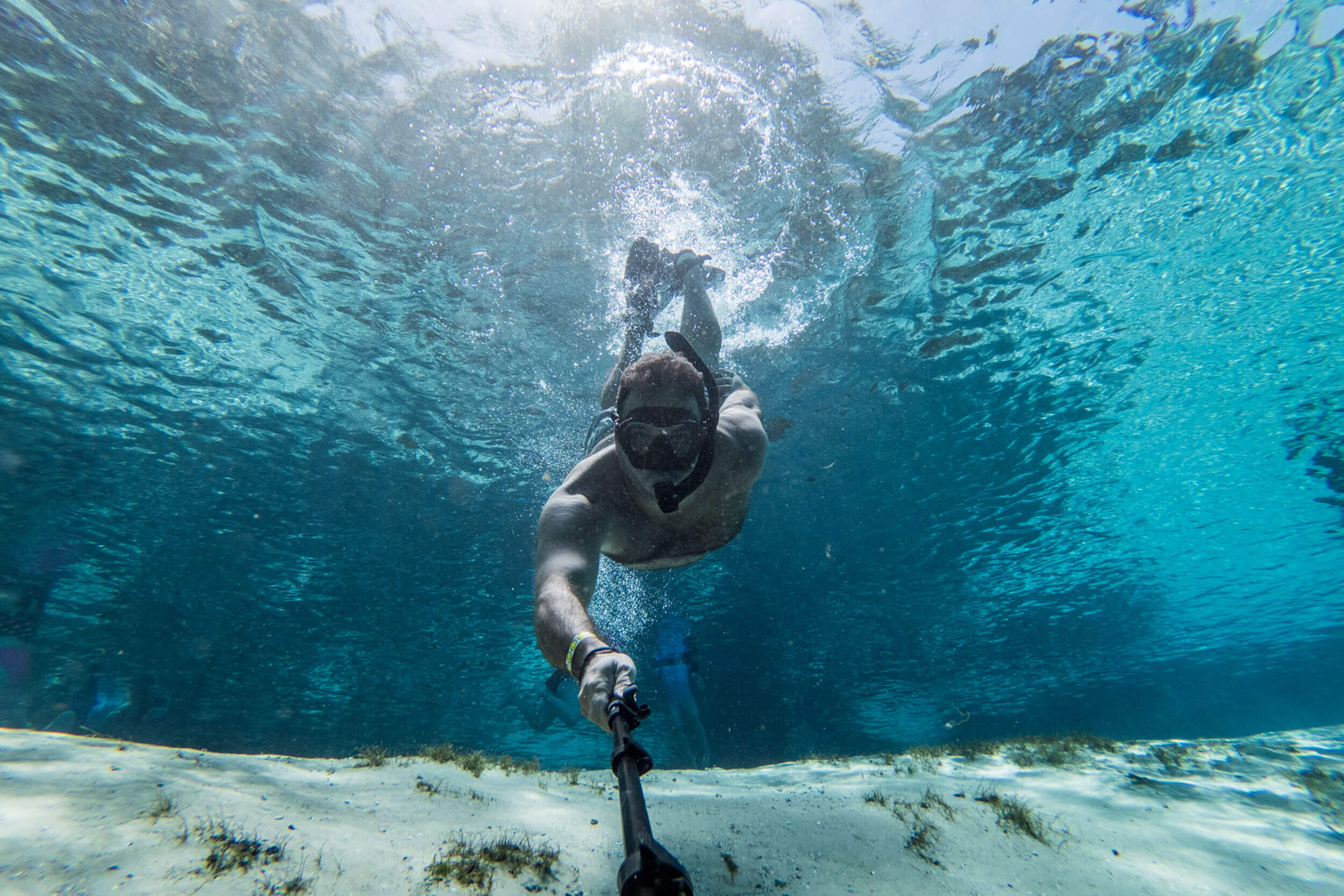 Man takes selfies under crystal clear waters of the Silver Glen Park in Florida.